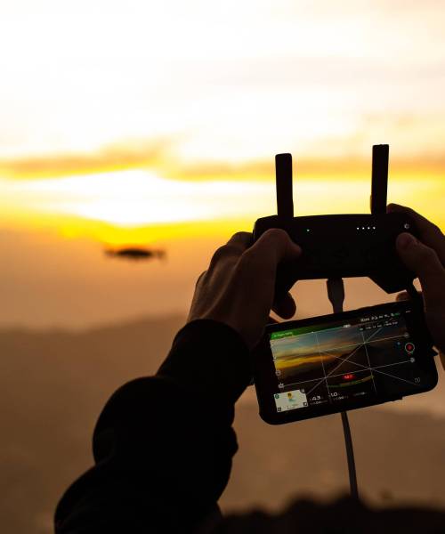 close-up. A man controls a drone in the dawn sun on the volcano BATUR. Bali Indonesia